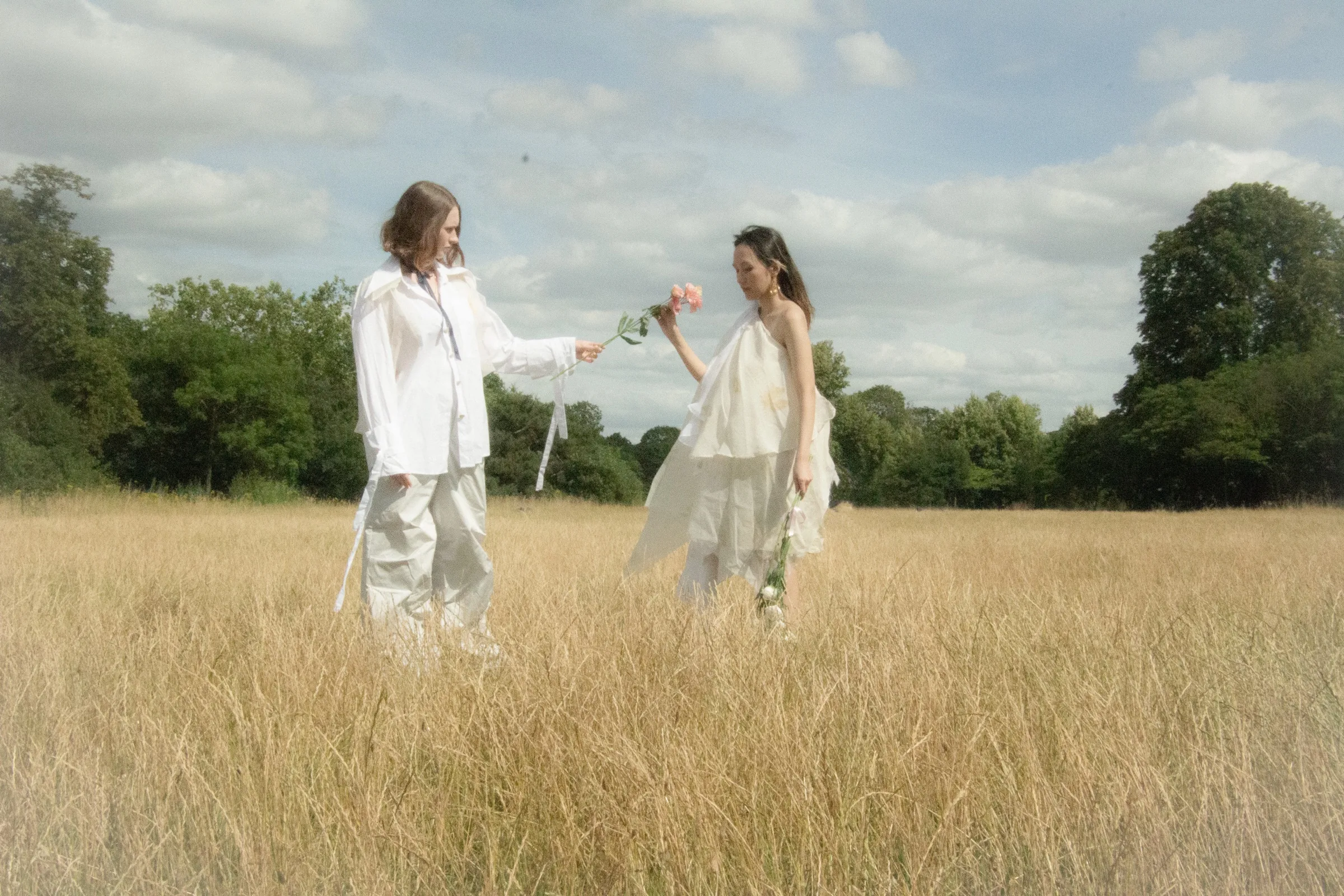 A flower passes between the two models in the wide field