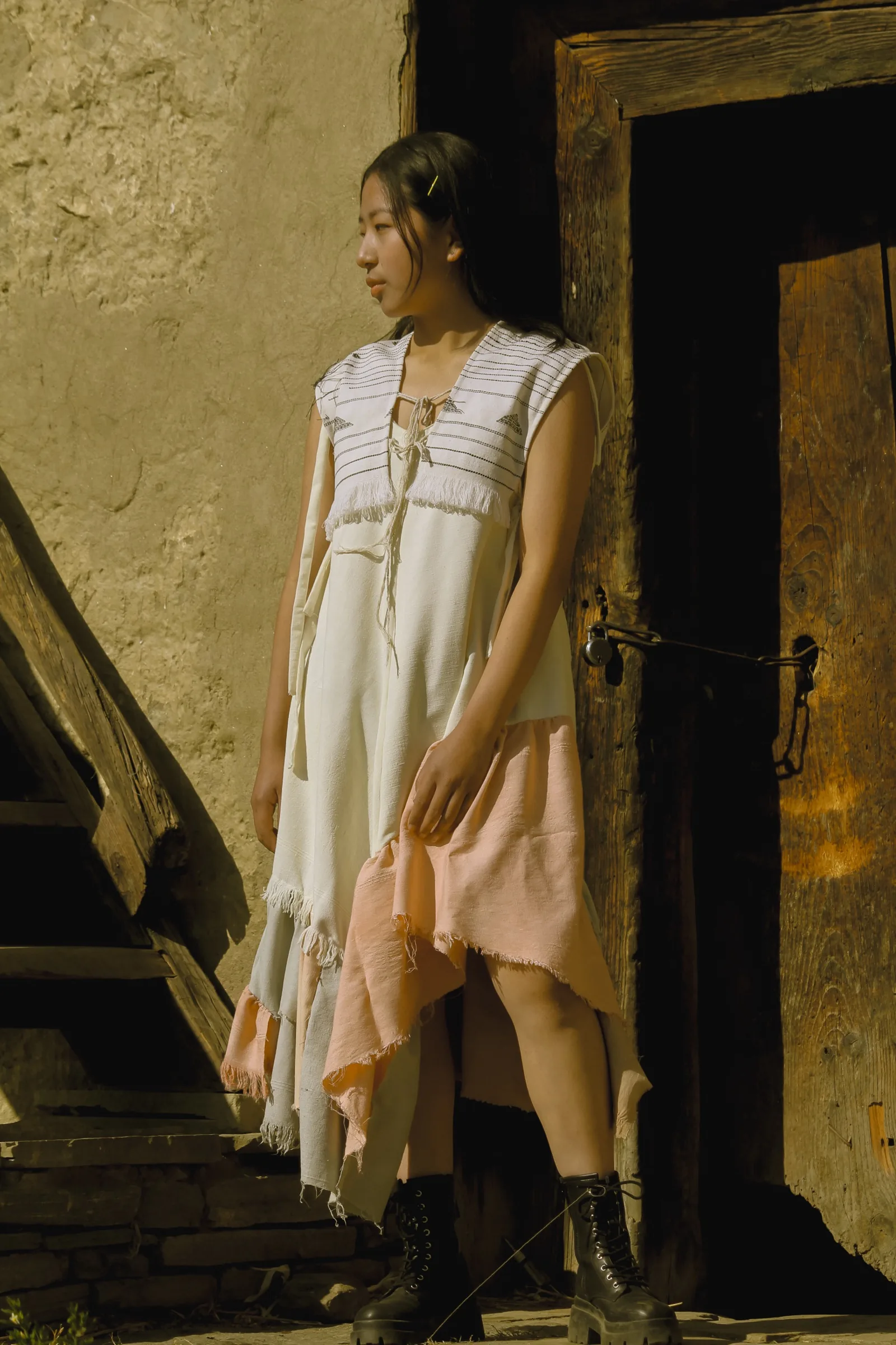 The naturally-dyed dress, white bodice with a peach and sage ruffled hem
