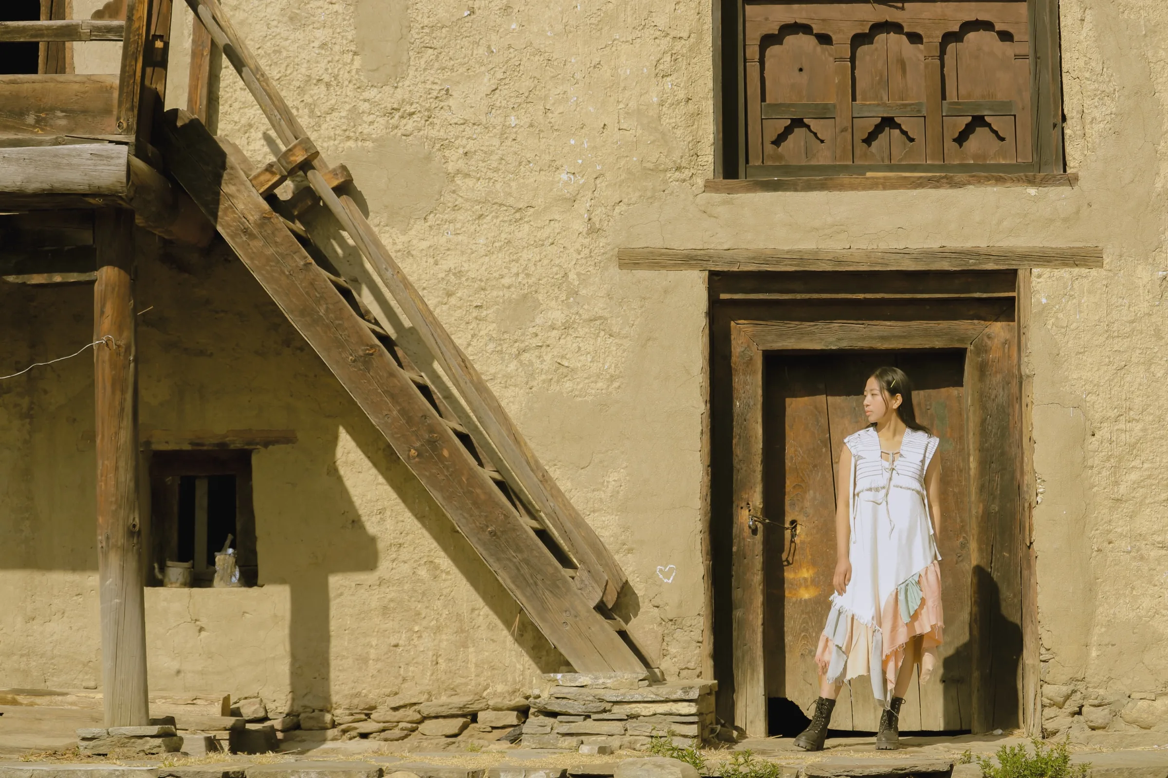 The dress beside a carved Bhutanese window