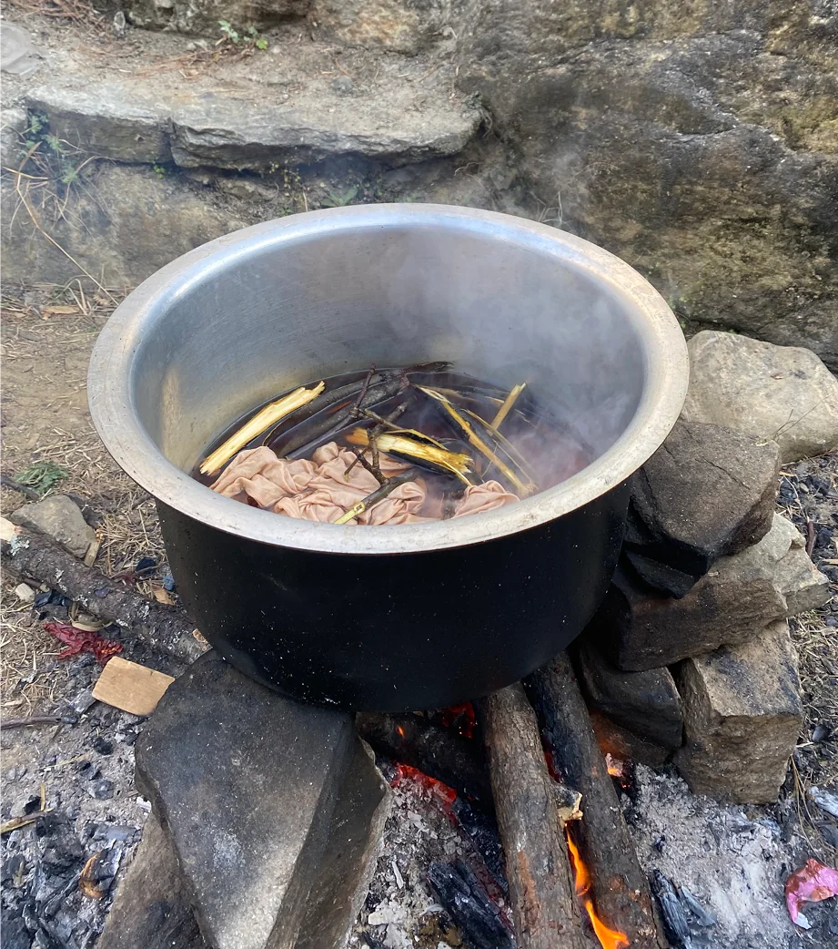 The dye pot set over an open fire