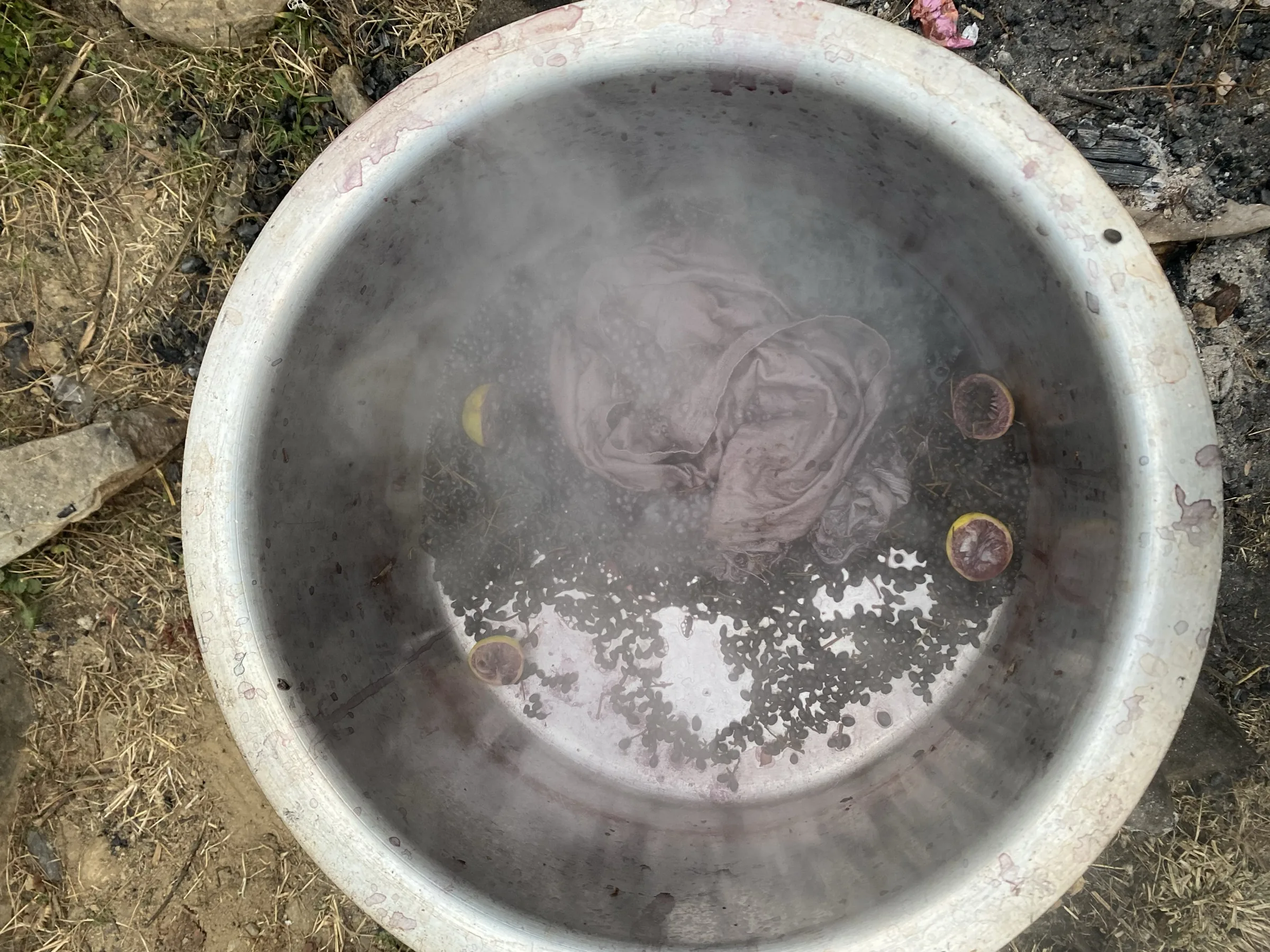 Cloth simmering in a dye vat over the fire