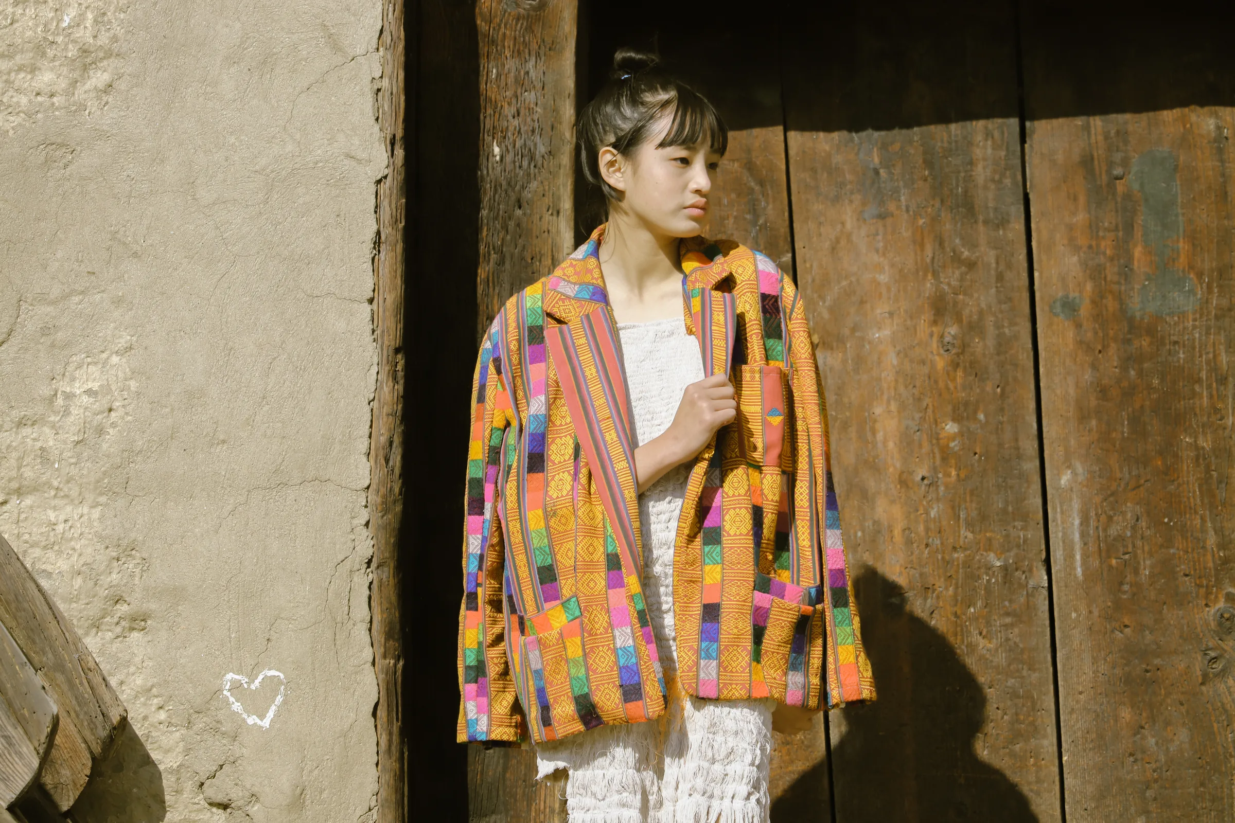 The patchwork jacket worn in a village doorway