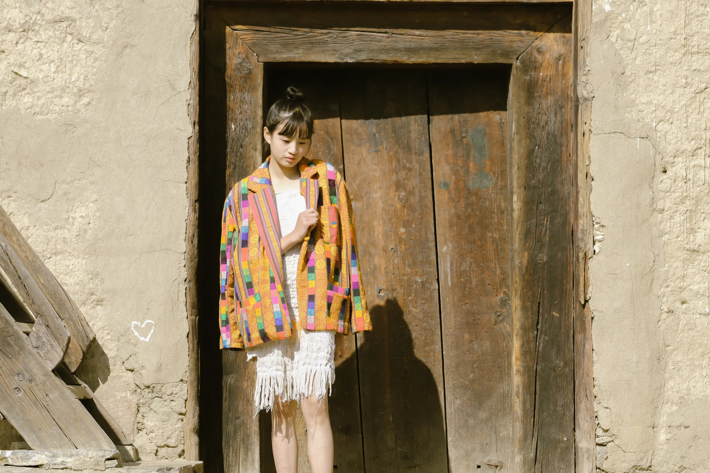 The jacket framed by a tall wooden doorway