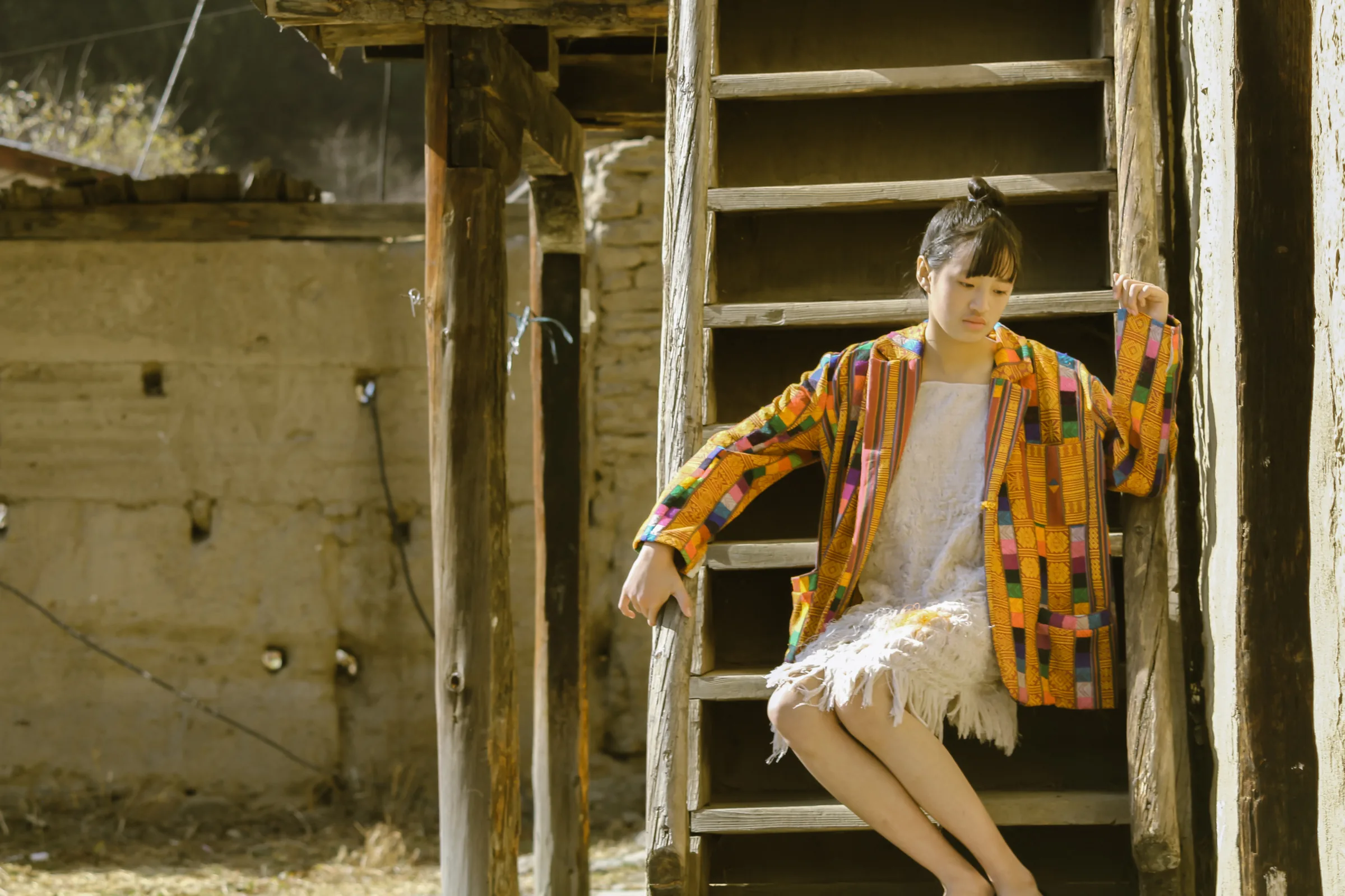 Resting against a wooden ladder in the remade jacket