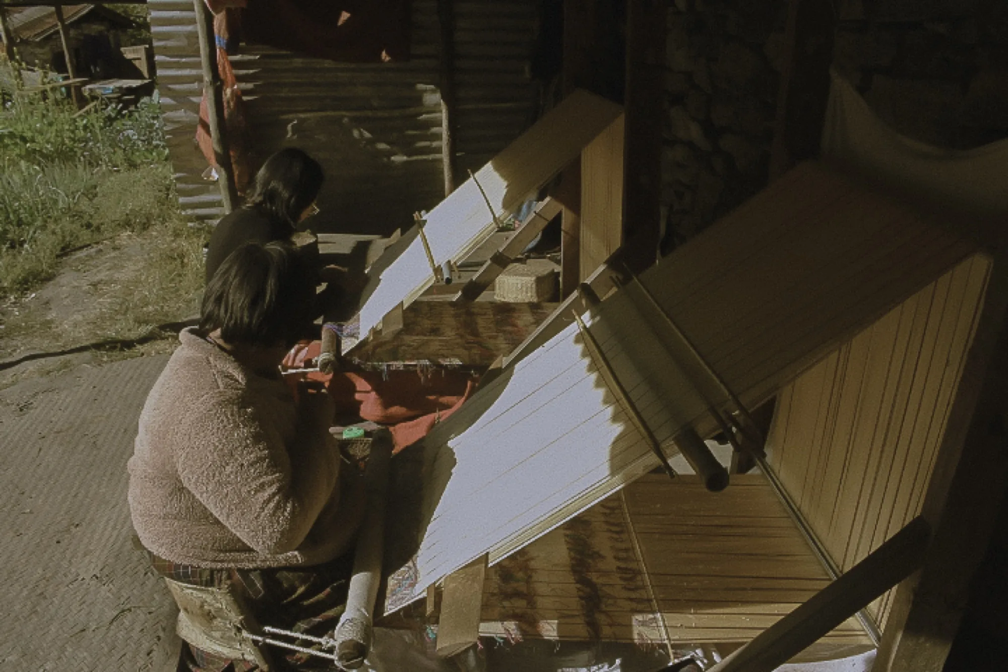 Two weavers on the porch