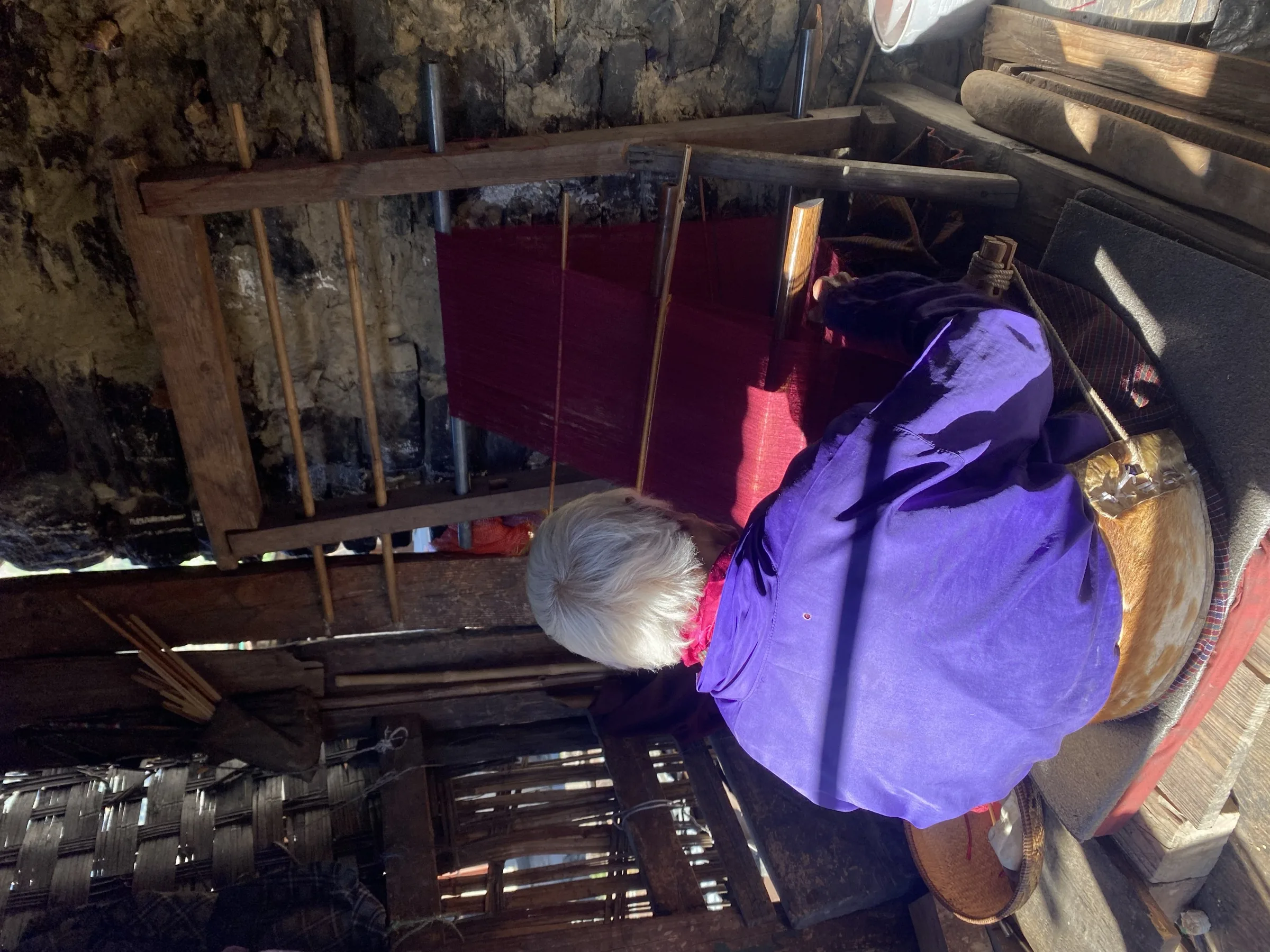 Sither Lhamo beside her loom